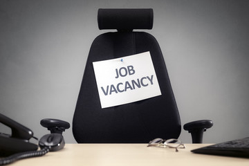 Chair with a job vacancy sign