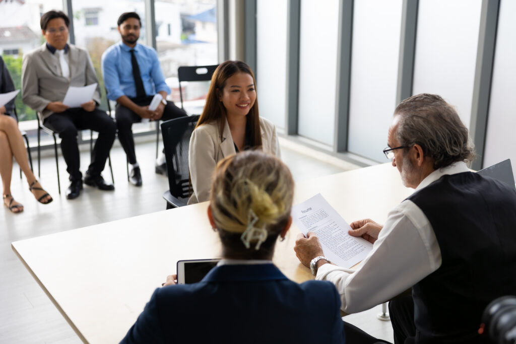 human resources : company, successful deal. human resources manager interviewing applicant at modern office. asian woman candidate job interviewing and answering question hr cv recruiter