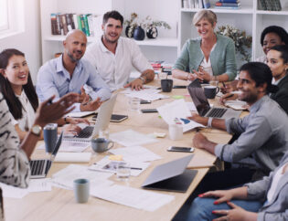 Businesspeople, presentation with leader planning and with laptop at desk in a office at their workplace. Teamwork or collaboration, business meeting and colleagues discussing together in a boardroom.